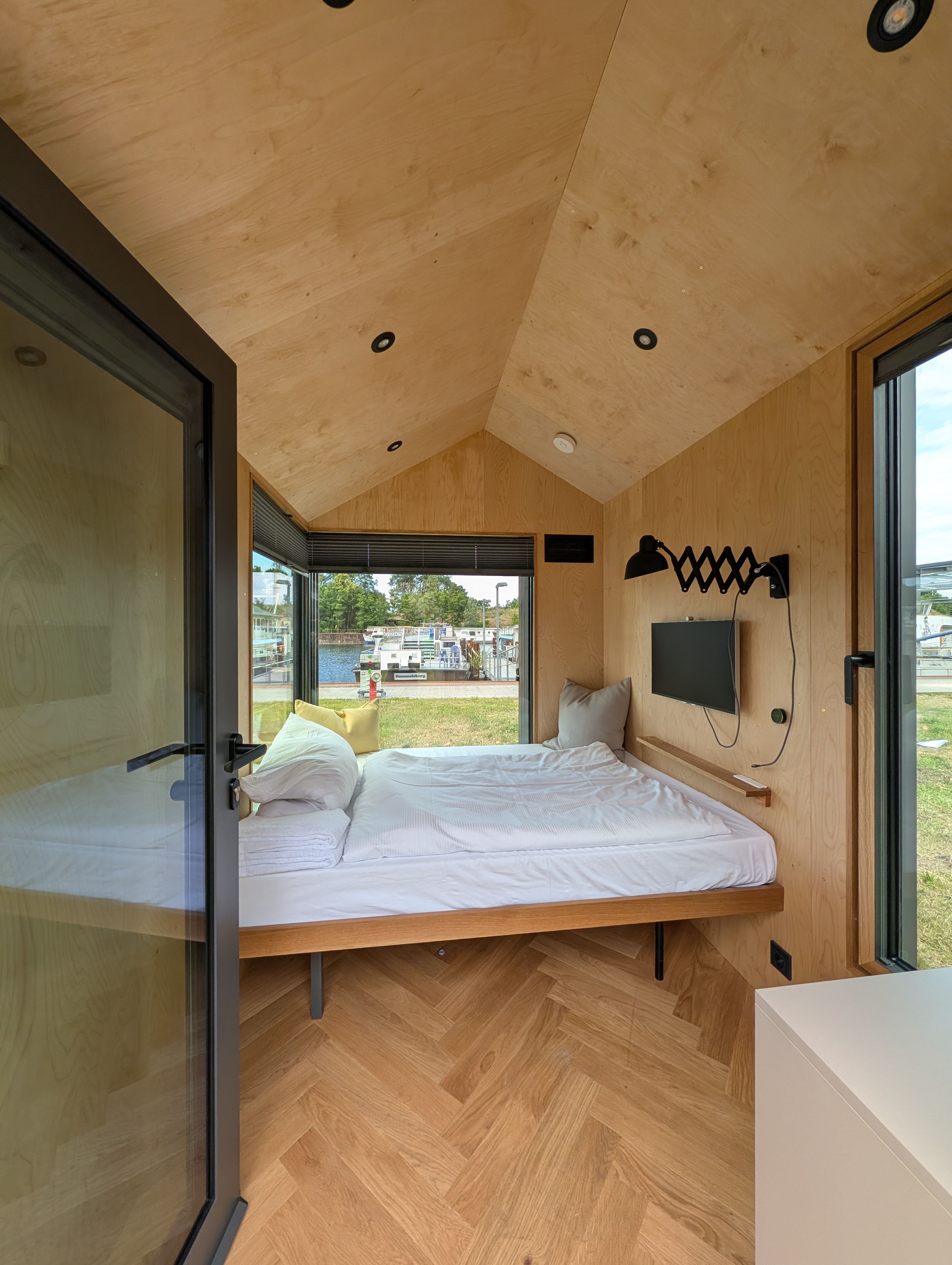 TINY Sleep interior with double bed and window to the water